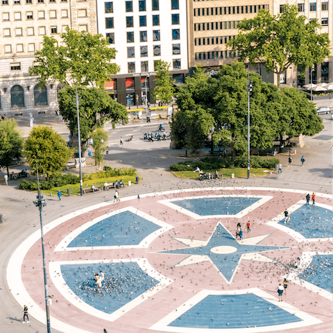 Visit the bustling Plaça de Catalunya, a nine-minute walk away