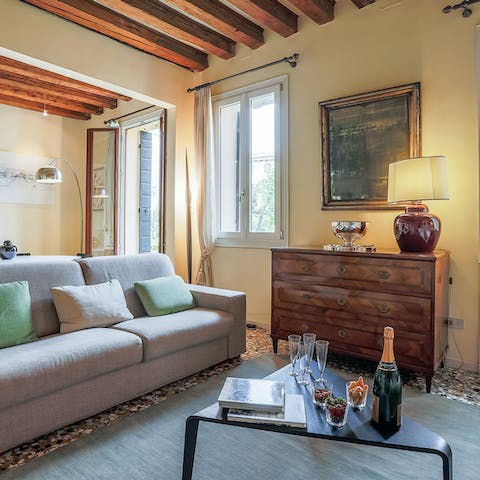 Enjoy a cool Aperol Spritz under the wooden beams in the living room