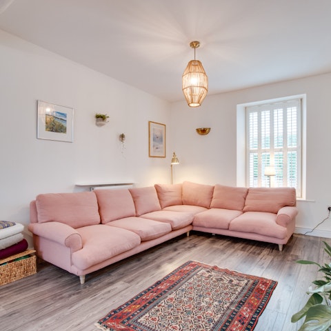 Curl up in the cosy aesthetic of the living room following sunny afternoons on the beach
