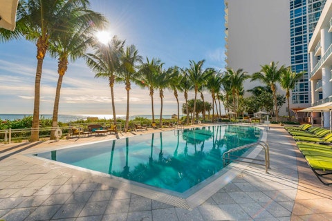 Cool off in the shared pool as the ocean glitters beyond