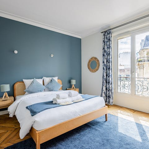 Wake up to a Parisian street view from the bedroom