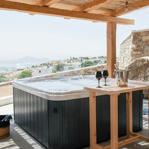 Relax with a glass of Greek wine in the hot tub