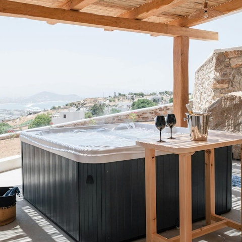 Relax with a glass of Greek wine in the hot tub