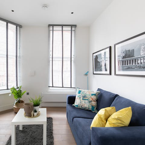 Relax in the bright living room with a glass of bubbly after a day of exploring the city on foot