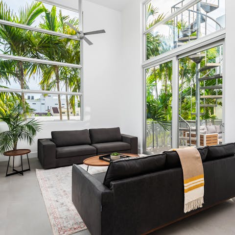 Gaze out at the sunshine on palms in the bright reading spot