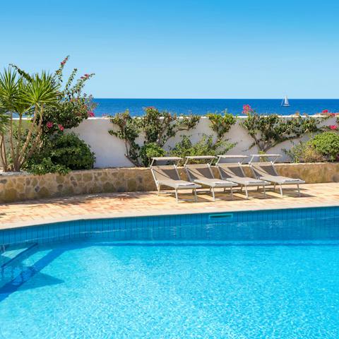 Stretch out poolside amongst the sea vistas