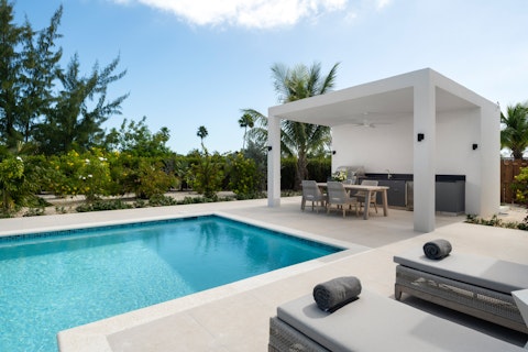 Stretch out poolside beneath open Caribbean skies