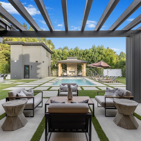 Clink drinks under the sun as the kids play in the heated pool