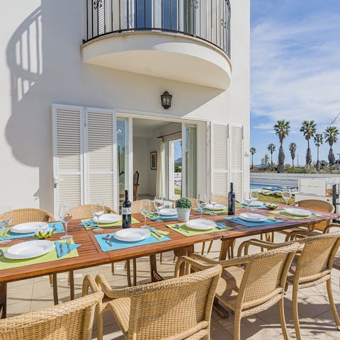 Dine al fresco and indulge in a scumptious Spanish feast of paella and red wine