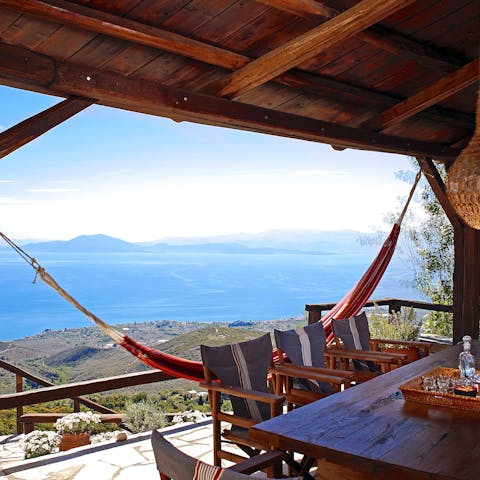 Relax in a hammock suspended over the ocean and shore below