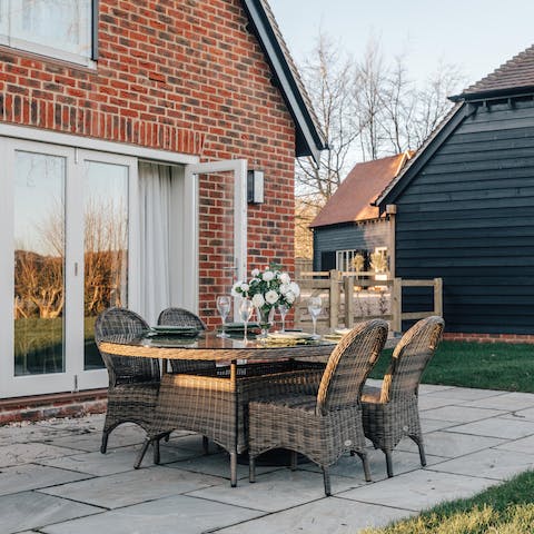 Dine on the home's patio underneath the blue summer sky