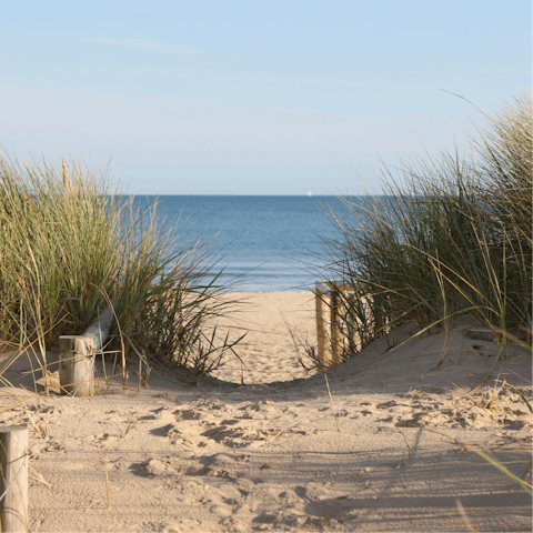 Take a seventeen-minute drive to the sandy shores of Tywyn Beach