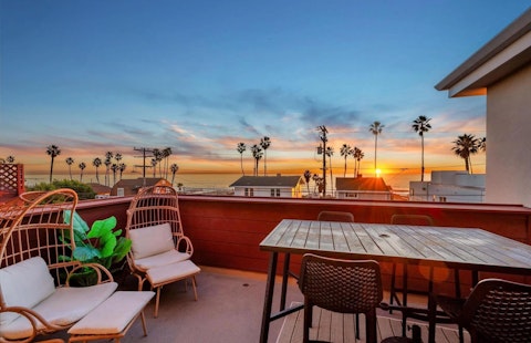 Watch the sun drop below the Pacific from palm-fringed seats