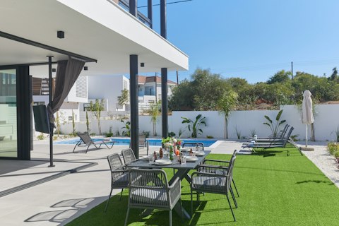 Gather around the outdoor table just steps from the water's edge