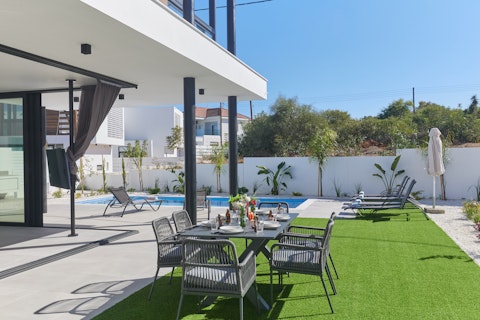 Gather around the outdoor table just steps from the water's edge