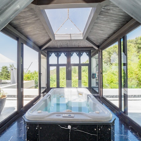 Relax and unwind after a day of exploring in the hot tub with views of the sky above you