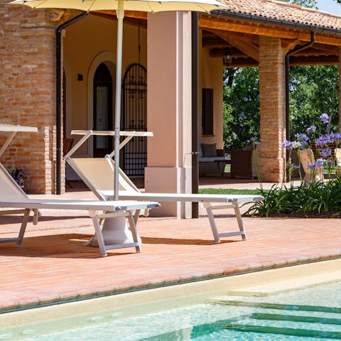 Set yourself up by the pool for a day of sunbathing and swimming