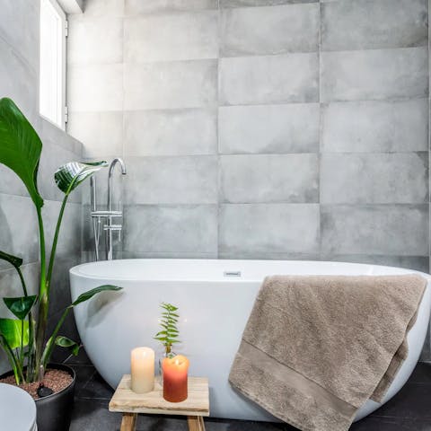 Sink into your sleek freestanding tub after a day out exploring Madrid