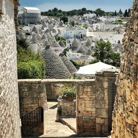 Wander through the streets of Alberobello with its conical buildings and whitewashed walls
