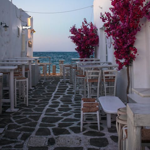 Visit the charming tavernas of Parikia, just a fifteen-minute drive away