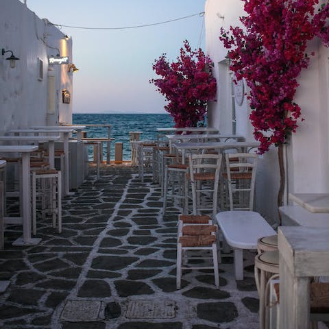 Visit the charming tavernas of Parikia, just a fifteen-minute drive away