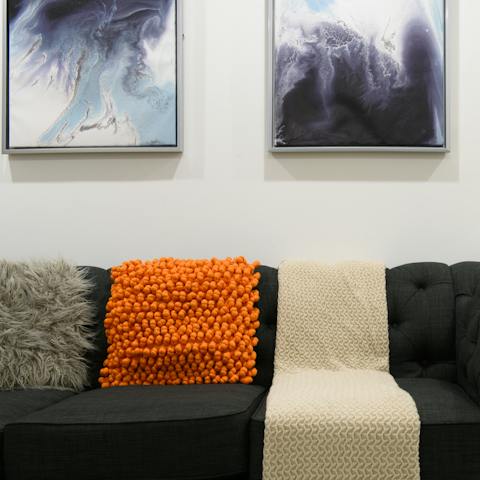 Enjoy the bold artwork against pristine white walls and pops of colour