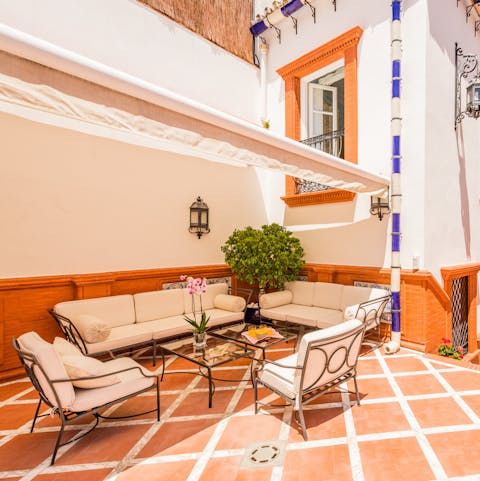 Enjoy a shady spot under the canopy, and sip a coffee on the outdoor sofa