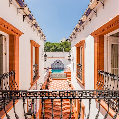 Admire the views of the pool from the balcony