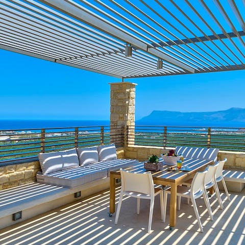 Dine alfresco on some locally caught fresh fish under the pergola