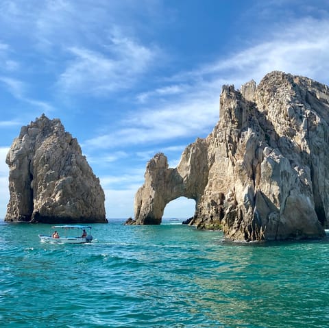 Explore the mesmerising El Arco de Cabo rock formations by boat