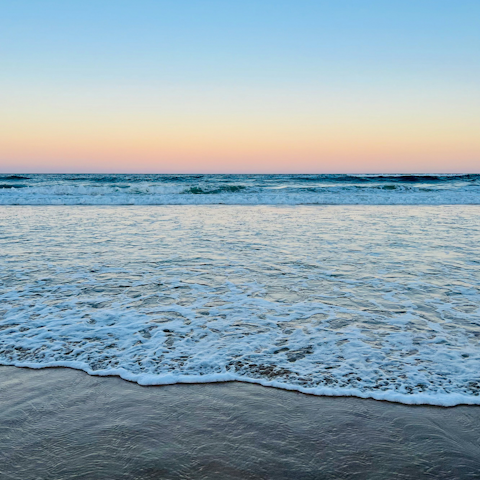 Catch sunsets at Kurrawa Beach, a twenty-five minute stroll away