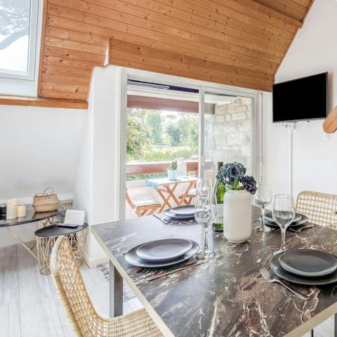 Enjoy wining and dining at the stylish marble table, on wicker chairs