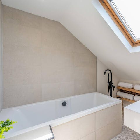 Run yourself a bubble bath in the sleek tub