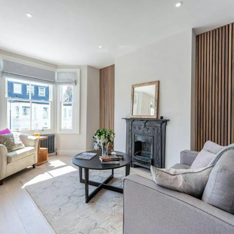 Relax in the cosy living room besides the period fireplace
