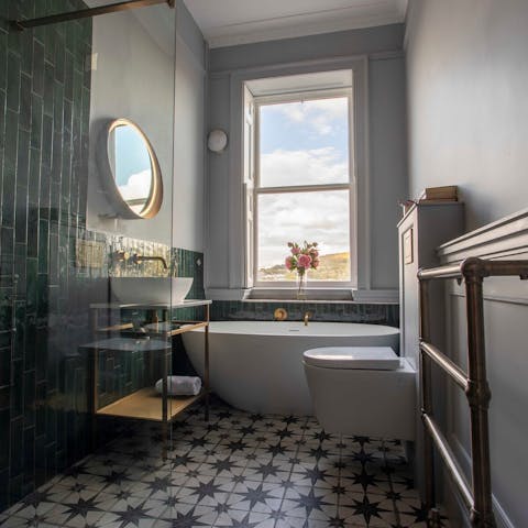 Enjoy a soothing soak in the free-standing bathtub