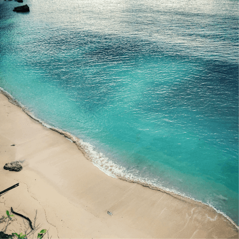 Swim the turquoise waters off Batu Bolong, a short drive away