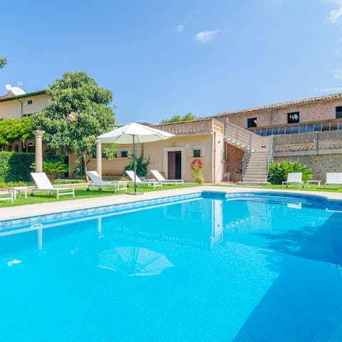 Swim laps in the huge, Roman-style swimming pool to cool off