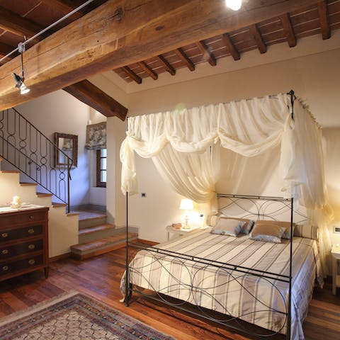Sleep under the romantic canopy of the master bed