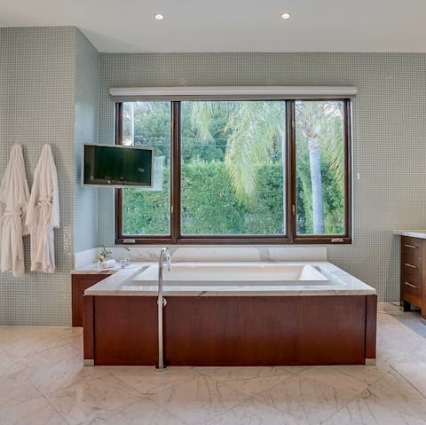 Treat yourself to long soaks in the bath with views across the trees