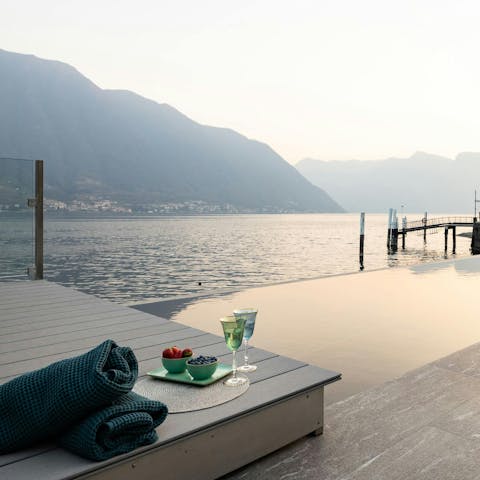 Drink in mesmerising lake views from the shared infinity pool