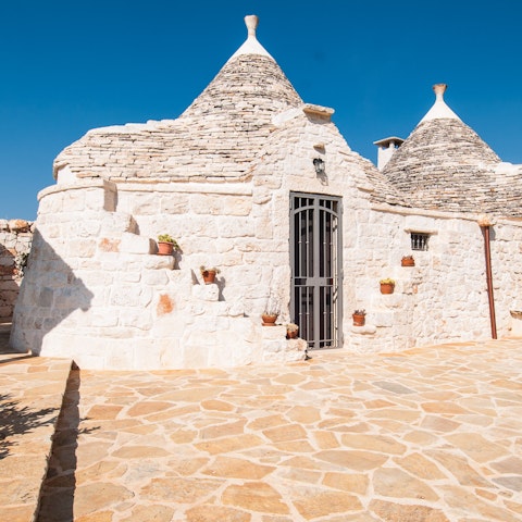 Stay in a home comprised of traditional trulli buildings