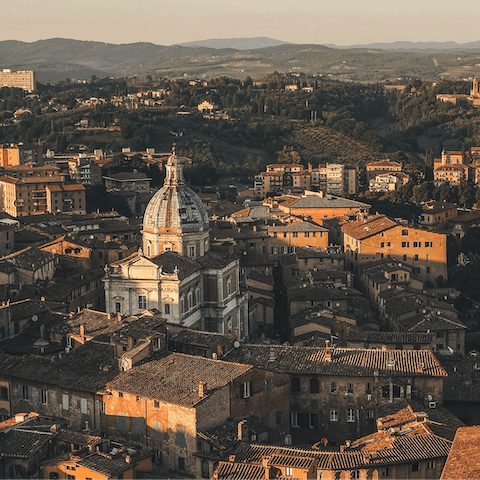 Spend a day strolling the historic streets of Siena – a short drive away