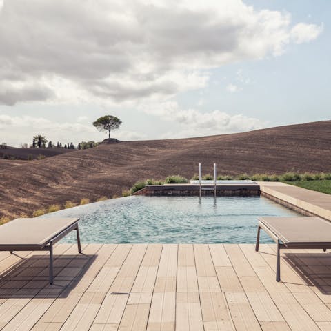 Enjoy uninterrupted views while relaxing by the pool
