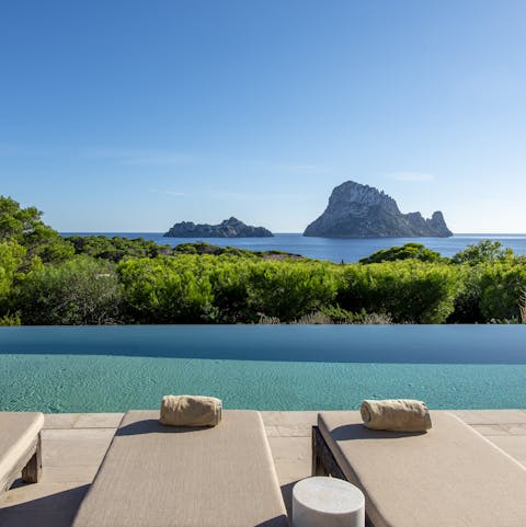 Admire the views of Es Vedra and the Mediterranean Sea from the pool