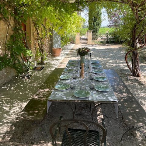 Gather for an alfresco meal under the shade of the pergola