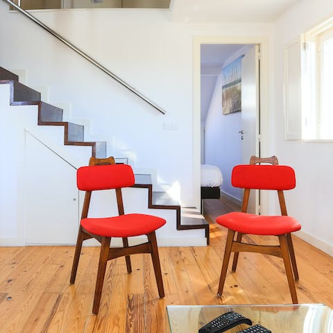Rest tired feet on the bright red chairs in the living area