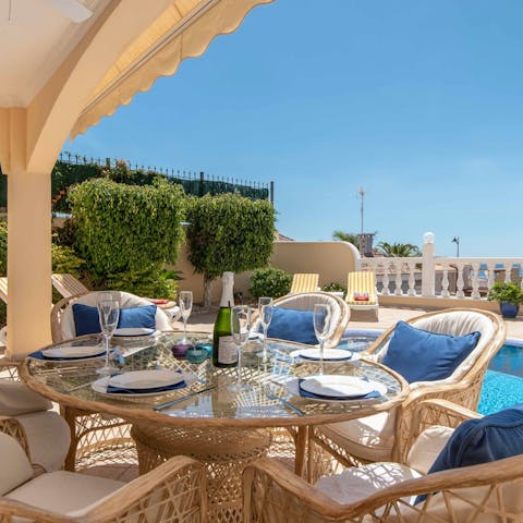 Dine alfresco overlooking the private pool