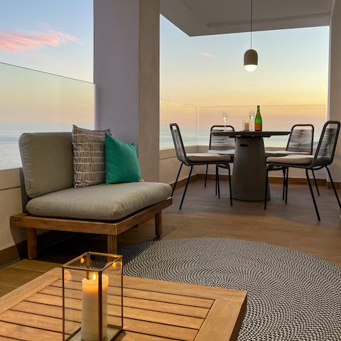 Pour out sangria during the golden hour, admiring a seascape from the balcony