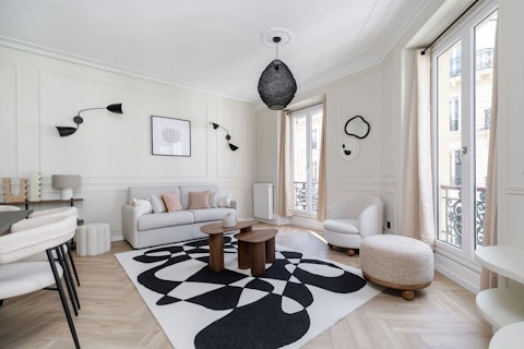 Stretch out in the light-filled room with classic Haussmann charm