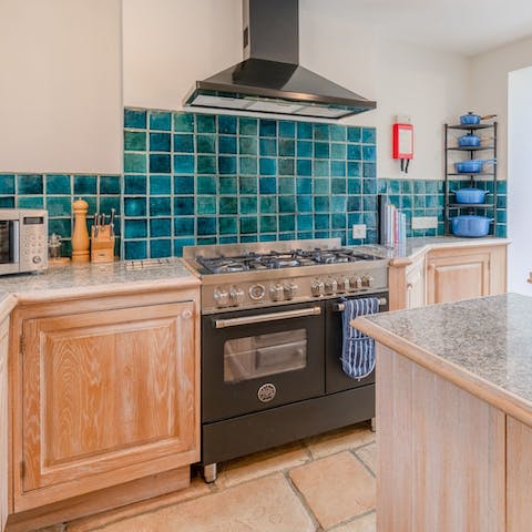 Prepare food together as a group in the polished kitchen, kitted out with a Britannia range cooker and Le Creuset cookware